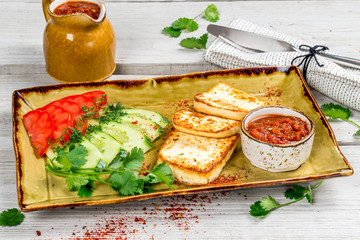 Brynza with fresh vegetables, tomatoes and cucumbers, served with sauce