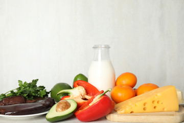 Different natural food rich in vitamin A on grey marble table