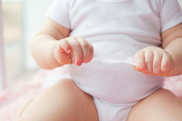 white feather in the hands of a child