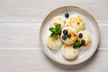 Curd pancakes or syrniki. Traditional Russian / Ukrainian cuisine, breakfast