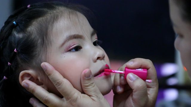 Mother  makeup her daughter , indoor  Chiangmai Thailand 