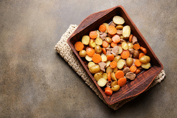 Roasted meat with vegetables in ceramic baking dish. Homemade food concept