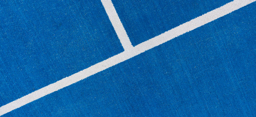 Colorful sports court background. Top view to blue field rubber ground with white line outdoors