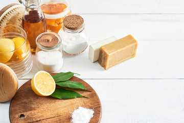 Eco-friendly natural cleaners: baking soda, soap, vinegar, salt, lemon and brush on table. Zero...