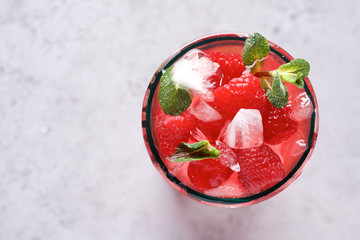 Raspberry lemonade with lime and ice. Cold refreshing cocktail