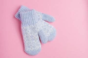 Blue mitten on pink background