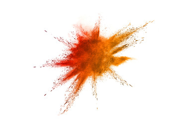 Abstract orange powder explosion. Closeup of orange dust particle splash isolated on white background.