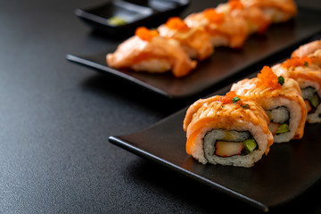 Fototapeta na wymiar grilled salmon sushi roll with sauce