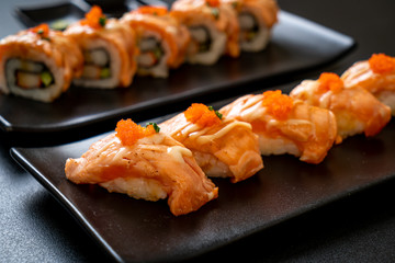grilled salmon sushi on black plate