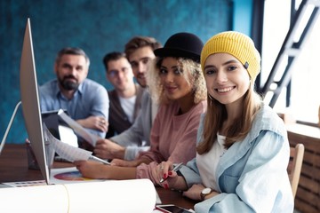 Successful team. Group of young business people working and communicating together in creative office.