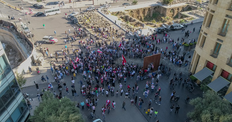 Beirut, Lebanon 2019: Aerial drone shot in Martyr's Square of numerous protesters trying to remove...