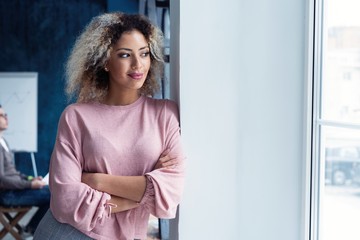 Fototapeta premium Modern young African business woman in the office with copy space.