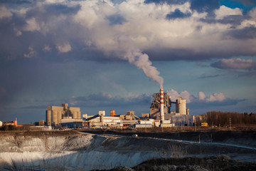 cement factory and chalk quarry against the sky with clouds