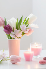 Tulips in vase and macaroons  on white background. Concept woman's or mother's day