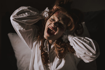 demonic girl in nightgown shouting in bedroom