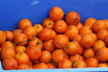 Pile of ripe mandarin fruits in a fruit stall