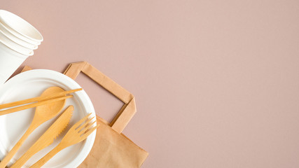Eco store banner design template. Empty kraft paper bag and eco-friendly cutlery set on brown...