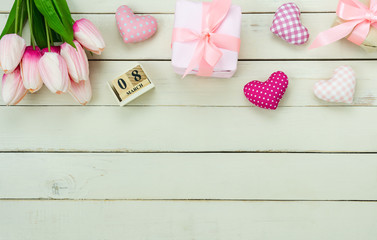 Table top view aerial image of decorations for international women's day  holiday concept background.Flat lay sign of season the word 8 march happy woman's day with heart shape on white wooden.