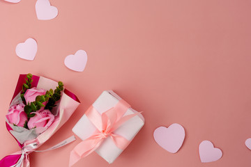 Table top view aerial image of decorations for international women's day  holiday concept background.Flat lay sign of season the word 8 march happy woman's day with flower and gift box on pink paper.