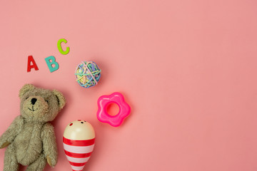 Table top view decoration kid toys for develop background concept.Flat lay accessories baby the doll bear with object on modern pink paper at office desk.Copy space for add text.pastel tone wallpaper.