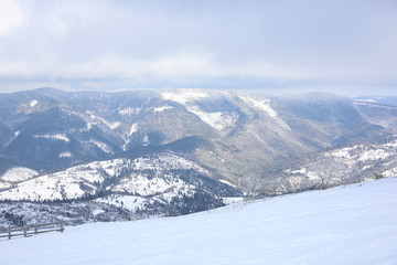 Fototapeta premium Picturesque view of snowy hills at mountain resort