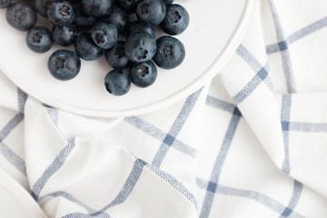 Beautiful healthy breakfast plate with strawberries and blueberries on a checkered napkin 