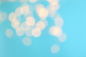 Blurred view of beautiful lights on blue background