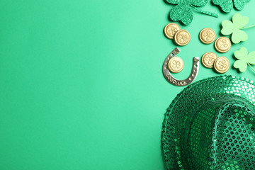 Flat lay composition with leprechaun hat on green background, space for text. St. Patrick's Day...