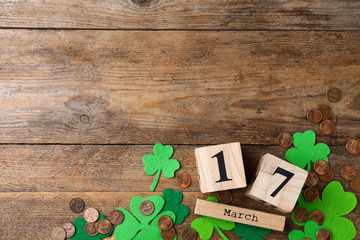 Flat lay composition with block calendar on wooden background, space for text. St. Patrick's Day celebration