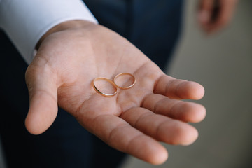 a gold ring lay on the palm of the man