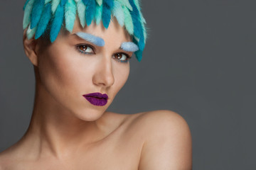 Closeup portrait of young beautiful woman with blue hair and eyebrows