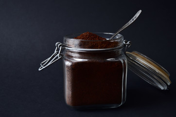 glass square jar with ground coffee