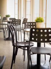 Fototapeta na wymiar Simple retro style coffee shop interior with white and black chairs