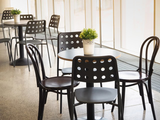 Simple retro style coffee shop interior with white and black chairs