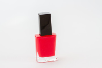 red nail polish bottle on white background