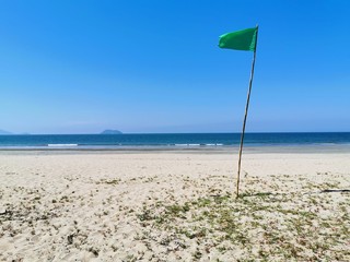 beach, sea, sand, umbrella, ocean, sky, summer, water, blue, parasol, travel, coast, vacation, tropical, sun, holiday, nature, tourism, landscape, yellow, horizon, flag, resort, sunshade, island