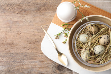 Rustic Easter table setting with eggs and floral decor, flat lay. Space for text