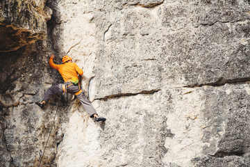 Man climbs a rock. 