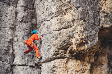 Woman climbs a rock. 