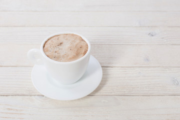 cup of coffee on white wooden table