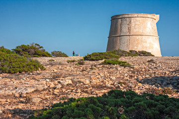Panoramic view of an ancient watchtower on the cliffs of Formentera in the Balearic Islands in...