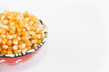 yellow round grains of natural dried corn in a decorative plate