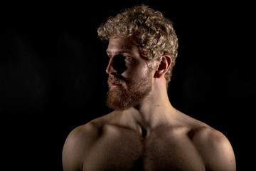 Beautiful muscles, athletic body. Studio photography on a black background, naughty light. Combat...