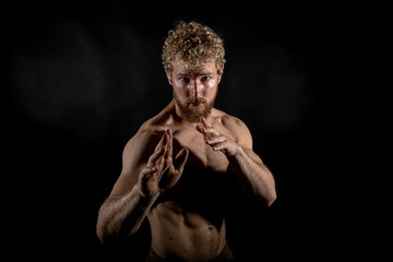 Beautiful muscles, athletic body. Studio photography on a black background, naughty light. Combat...
