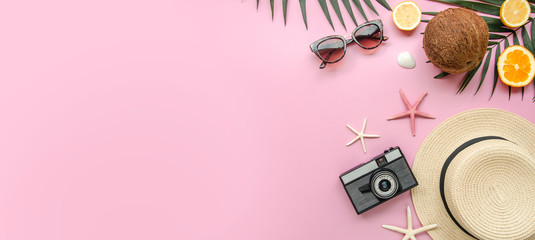 Summer holiday trip concept, top view beach women's accessories: straw hat, sunglasses and sea on a pink background. Vacation banner with copy space