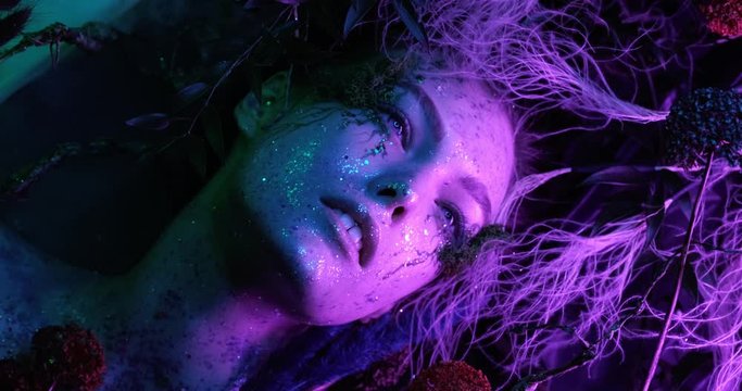 Beautiful high fashion model, cosplay avatar girl lies among the magical fog in the forests of the planet Pandora in neon colors and beautiful glows, shot in 4K close-up, bright and saturated
