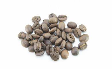 A small pile of roasted light brown coffee beans is scattered on a white isolated background. Natural whole grains without processing