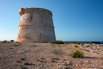 Panoramic view of an ancient watchtower on the cliffs of Formentera in the Balearic Islands in...