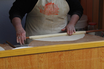 A house wife rolling the dough