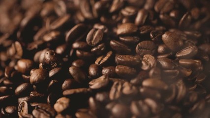closeup of roasted coffee beans with smoke